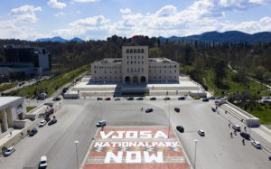 A huge banner in Tirana in Albania that says "Vjosa National Park Now."